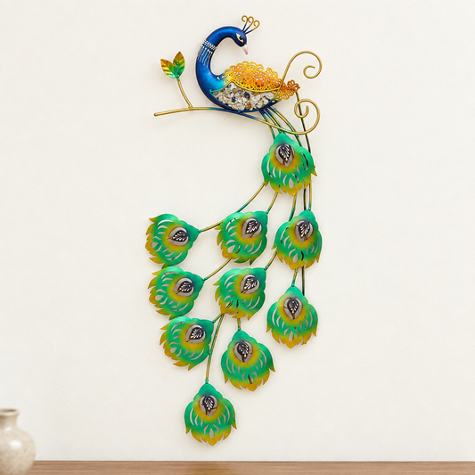 Tall multicolour peacock metal wall art displayed on an ivory wall above a wooden console with a small vase.